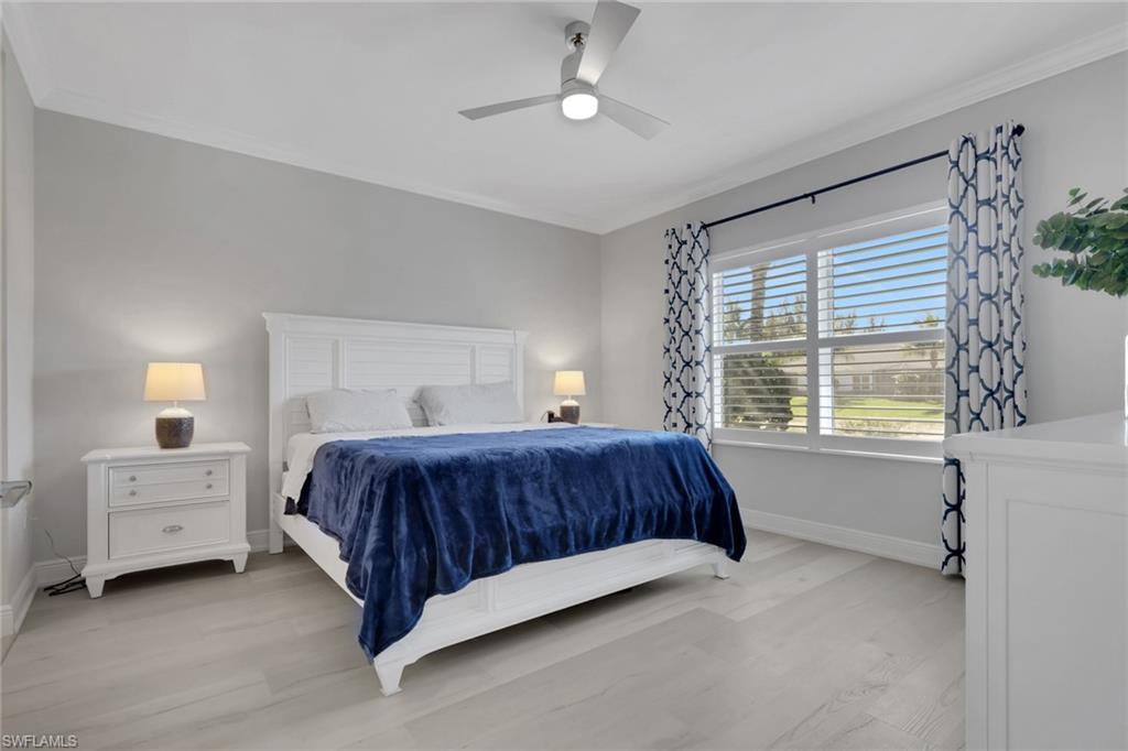 2194 Marquesa Circle Naples, FL 34112 - Photo 13 of 38 a spacious bedroom with a bed and a window