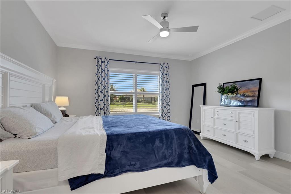 2194 Marquesa Circle Naples, FL 34112 - Photo 14 of 38 a bedroom with a large bed and a dresser