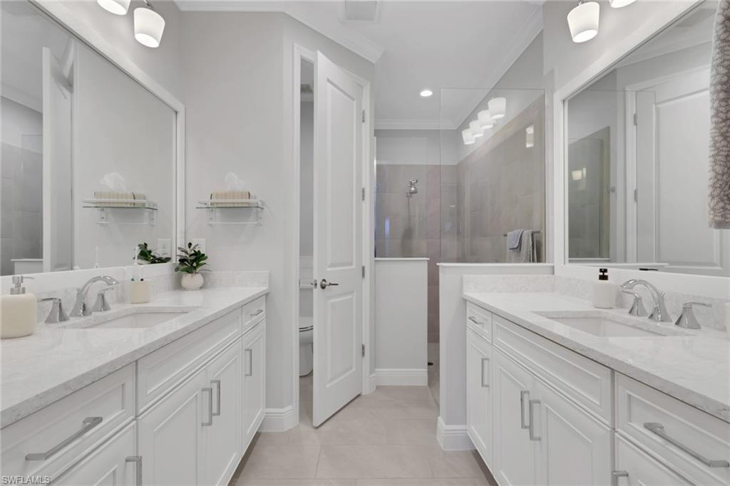 2194 Marquesa Circle Naples, FL 34112 - Photo 15 of 38 a bathroom with a sink double vanity and a mirror