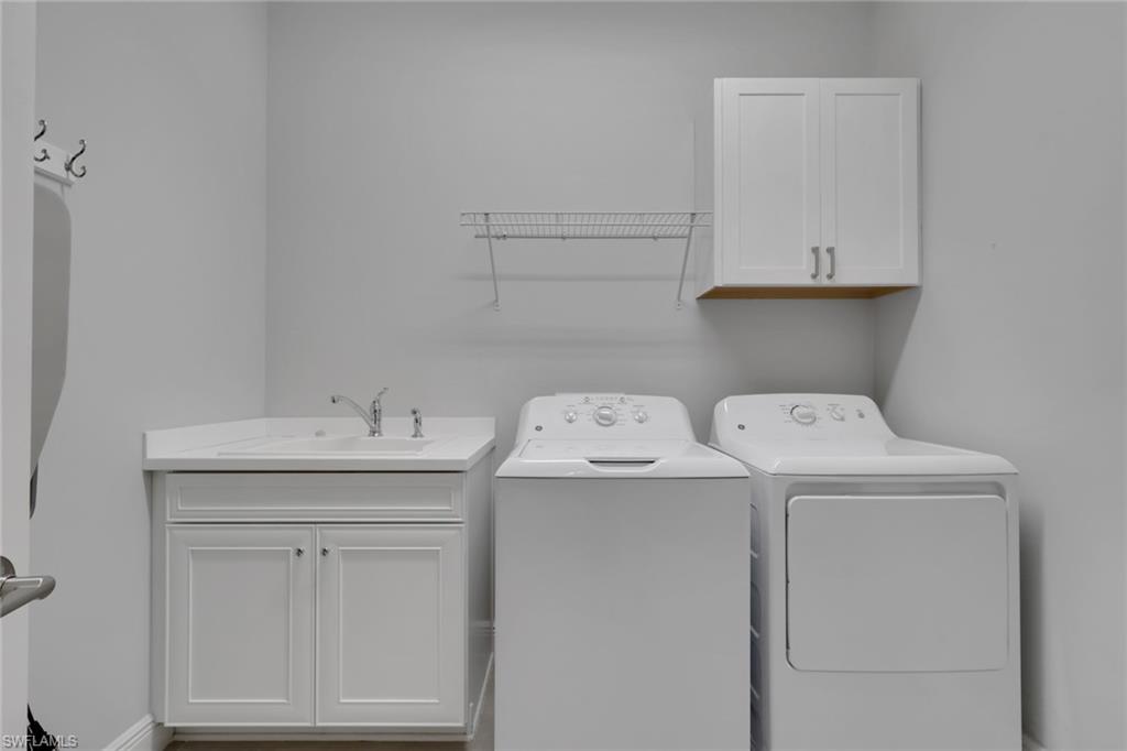 2194 Marquesa Circle Naples, FL 34112 - Photo 17 of 38 a utility room with dryer and washer