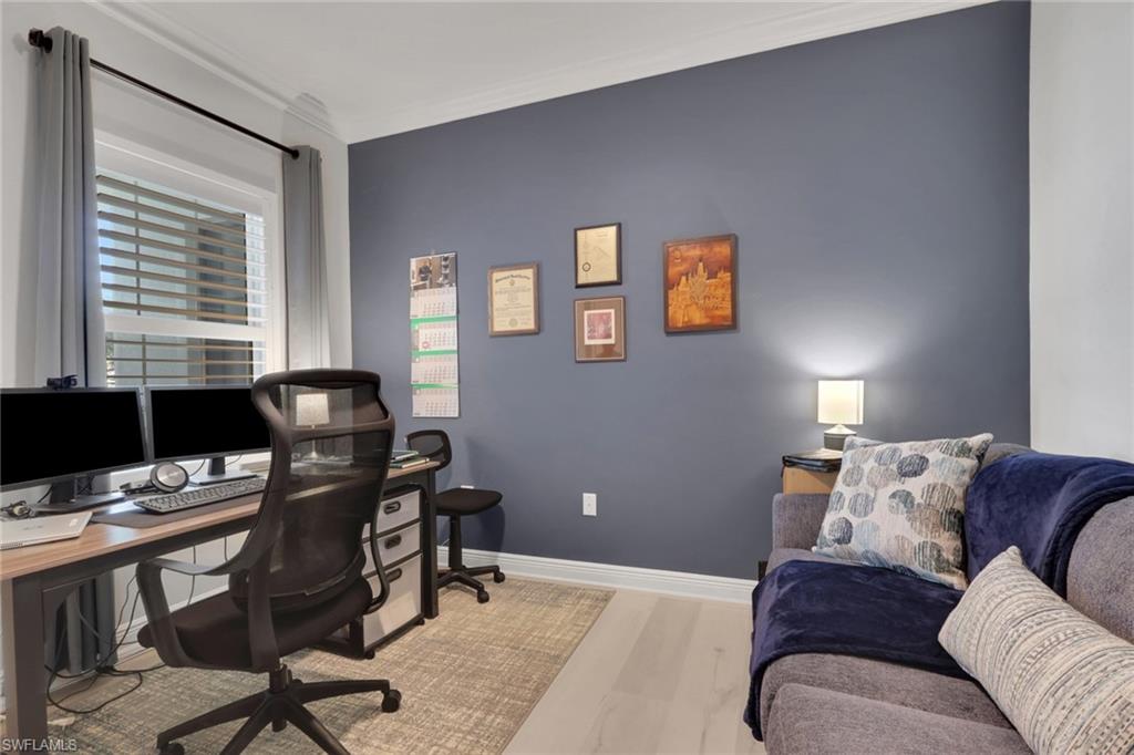 2194 Marquesa Circle Naples, FL 34112 - Photo 18 of 38 a livingroom with workspace and a couch
