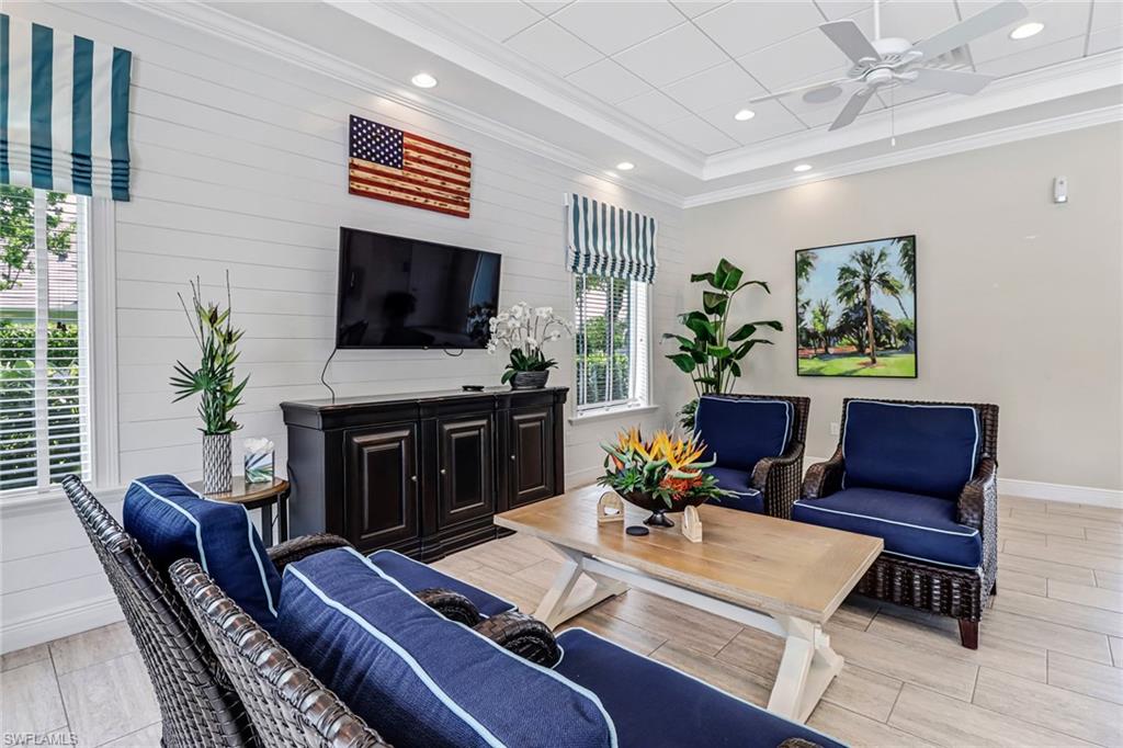 2194 Marquesa Circle Naples, FL 34112 - Photo 29 of 38 a living room with furniture and a flat screen tv