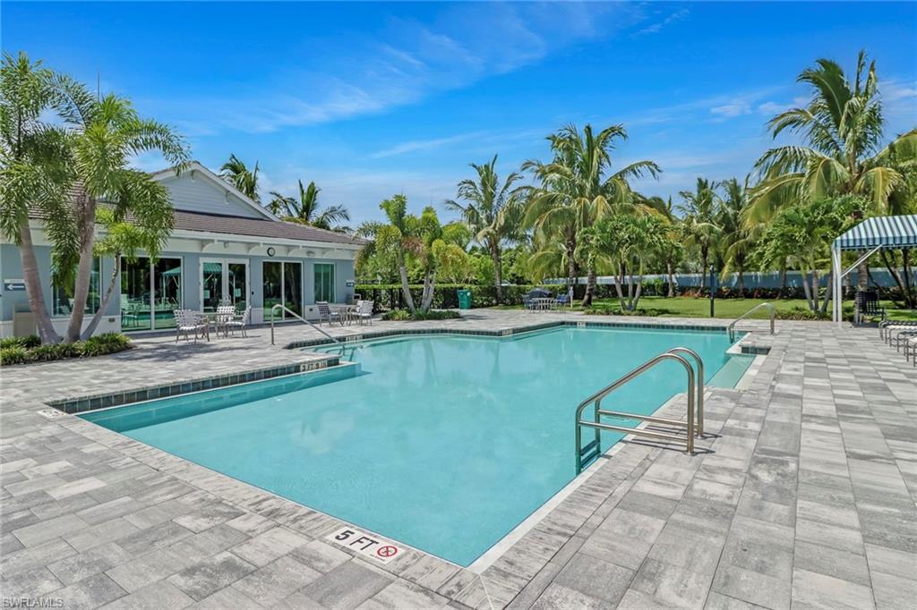 2194 Marquesa Circle Naples, FL 34112 - Photo 36 of 38 a swimming pool with outdoor seating and yard