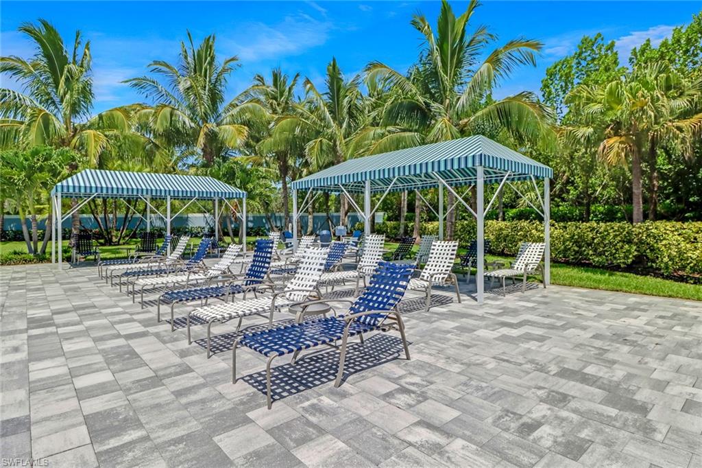 2194 Marquesa Circle Naples, FL 34112 - Photo 37 of 38 a view of a patio with a table and chairs under an umbrella