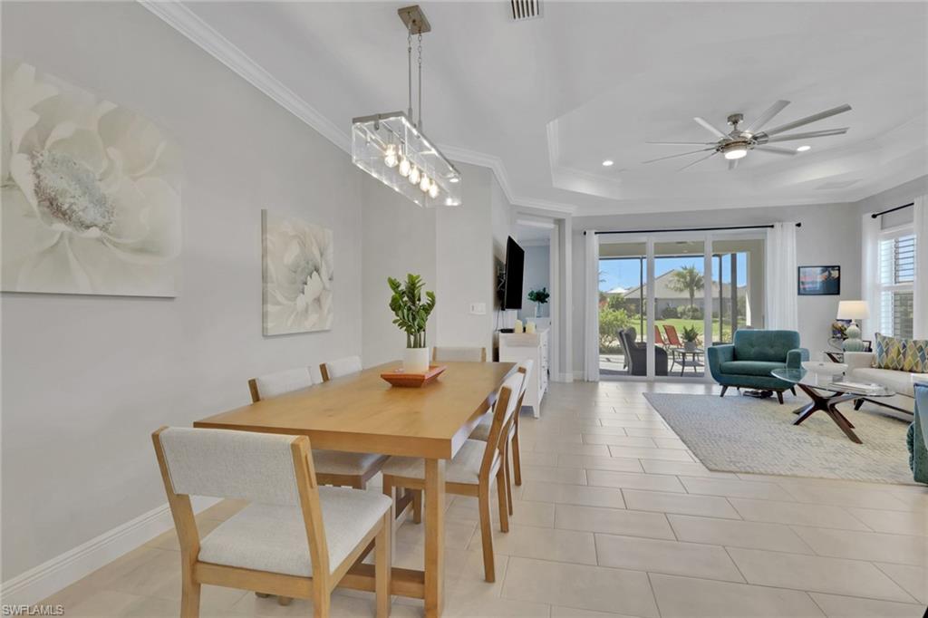 2194 Marquesa Circle Naples, FL 34112 - Photo 9 of 38 a view of a dining room with furniture window and wooden floor