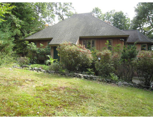 5 Wayside Inn Road Framingham, MA 01701 - Photo 1 of 11 a backyard of a house with plants and large tree