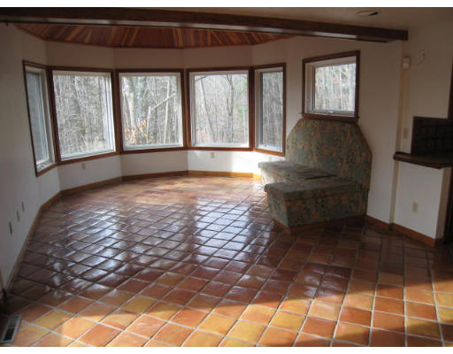 5 Wayside Inn Road Framingham, MA 01701 - Photo 8 of 11 a living room with a large window couches and kitchen view