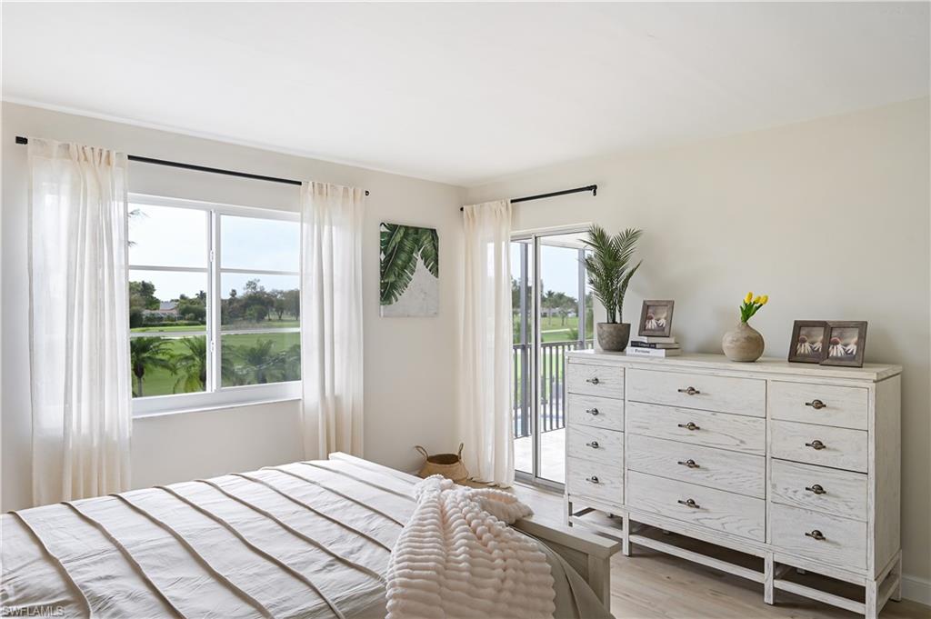 190 Pebble Beach Boulevard, Unit 202 Naples, FL 34113 - Photo 15 of 36 a bedroom with a large bed and a window