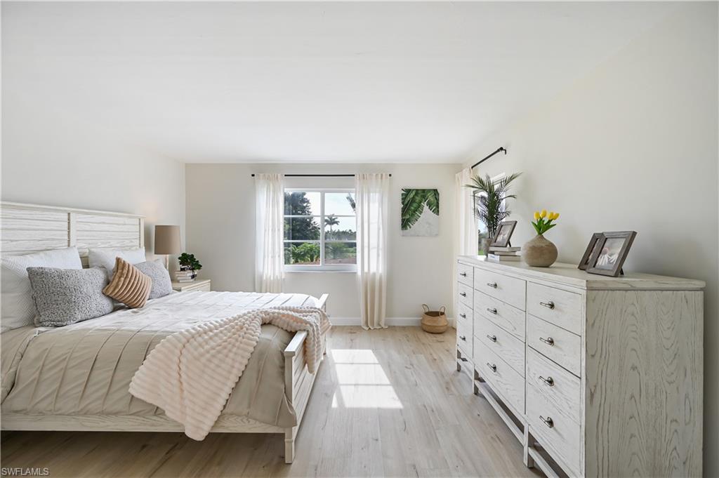 190 Pebble Beach Boulevard, Unit 202 Naples, FL 34113 - Photo 16 of 36 a bedroom with a bed and a window