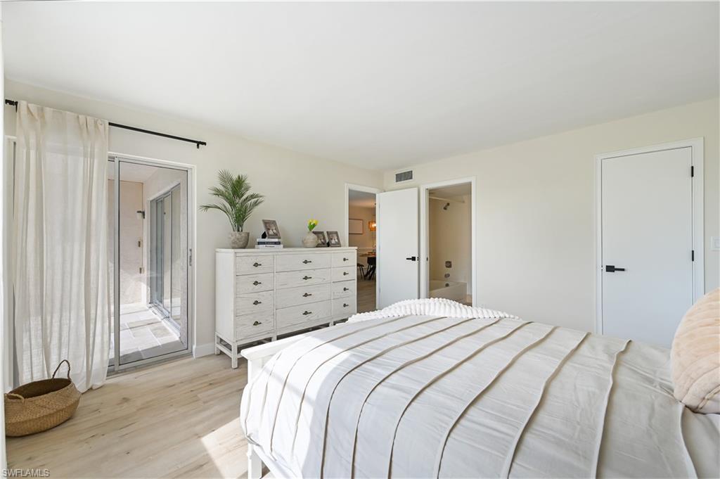 190 Pebble Beach Boulevard, Unit 202 Naples, FL 34113 - Photo 20 of 36 a bedroom with a bed and a television