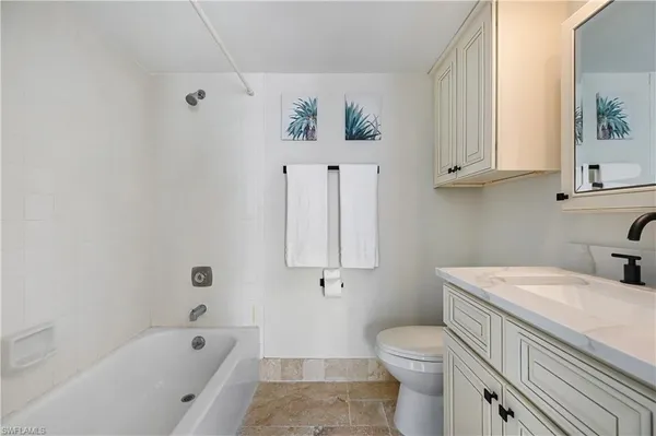 a bedroom with bed and wooden floor