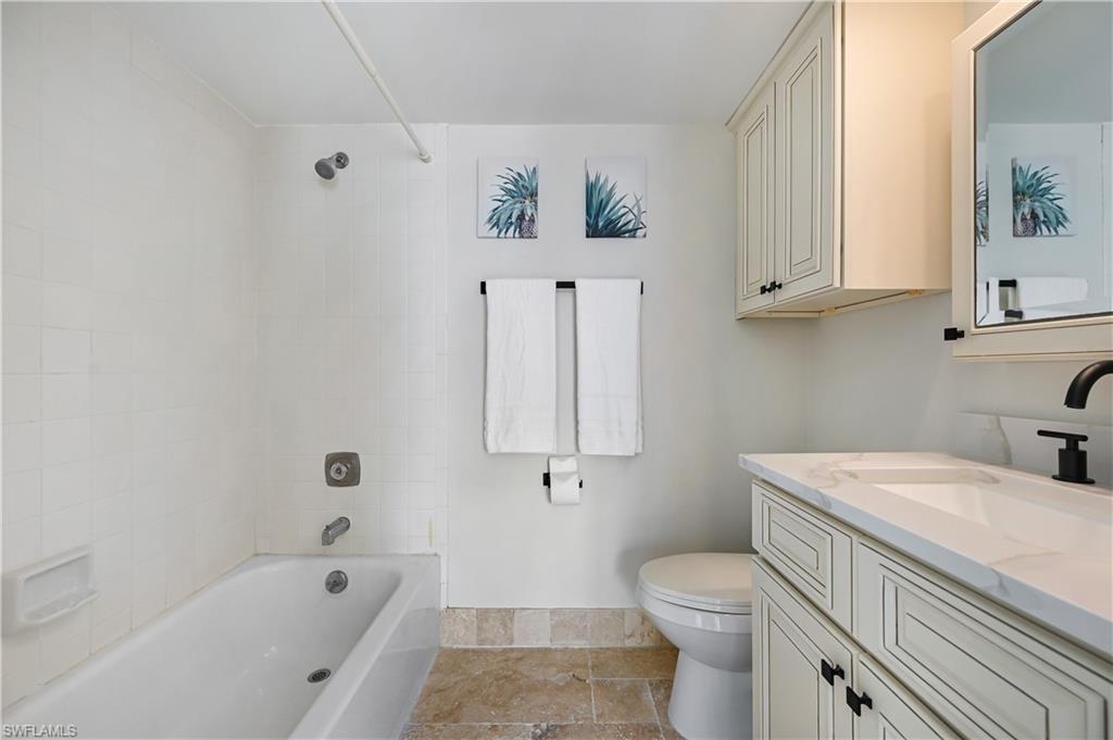 190 Pebble Beach Boulevard, Unit 202 Naples, FL 34113 - Photo 21 of 36 a bathroom with a sink a toilet and bathtub