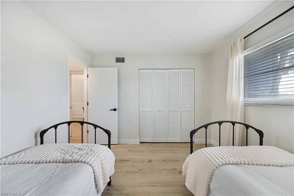 190 Pebble Beach Boulevard, Unit 202 Naples, FL 34113 - Photo 24 of 36 a bedroom with a bed and a table