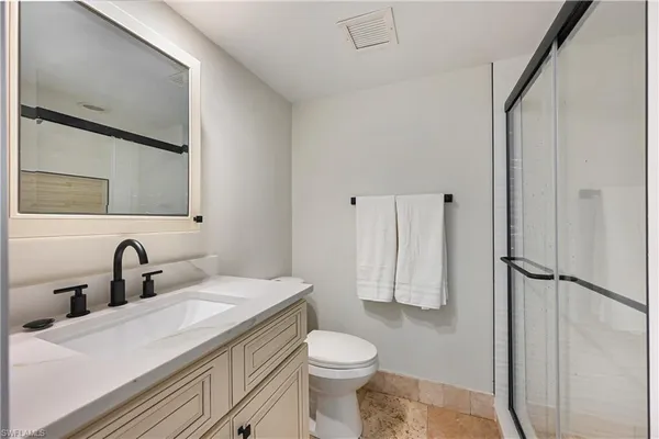 a bedroom with a bed and a table