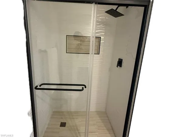 a view of a bedroom with furniture and window