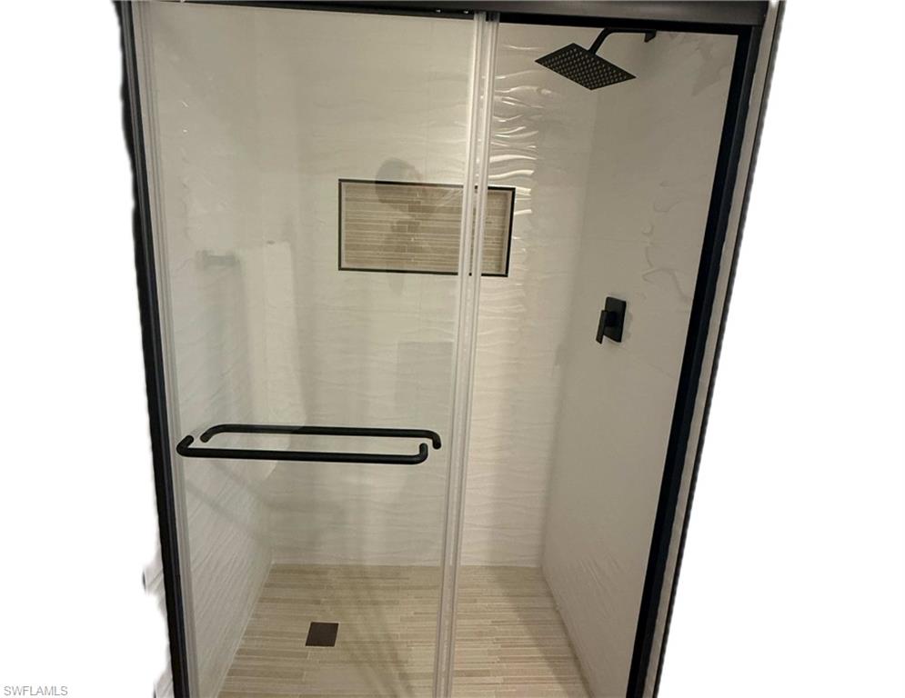 190 Pebble Beach Boulevard, Unit 202 Naples, FL 34113 - Photo 27 of 36 a bathroom with a shower