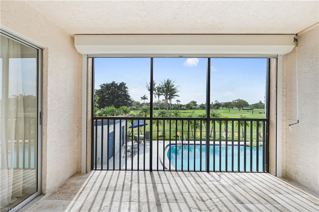 190 Pebble Beach Boulevard, Unit 202 Naples, FL 34113 - Photo 28 of 36 a view of a balcony with floor to ceiling window