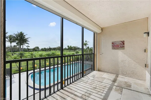a view of a balcony with floor to ceiling window