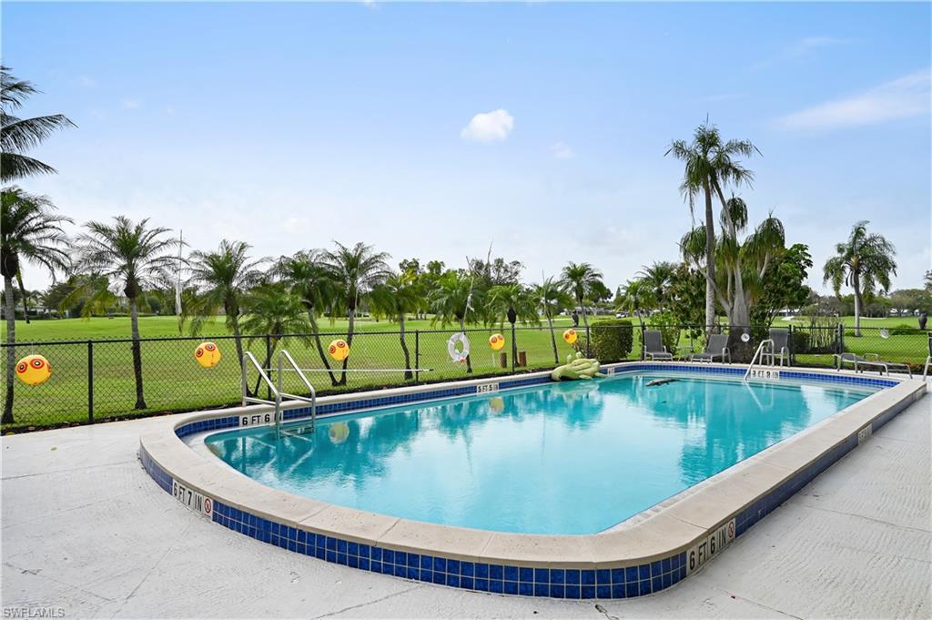 190 Pebble Beach Boulevard, Unit 202 Naples, FL 34113 - Photo 33 of 36 a view of a swimming pool with a yard