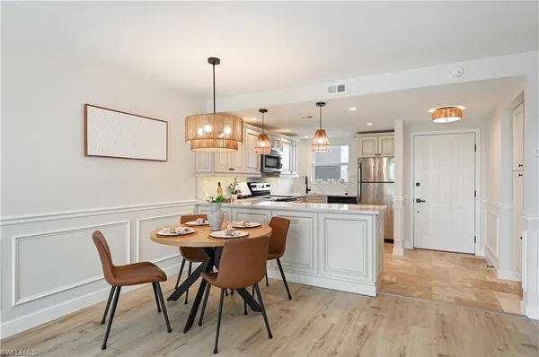 a dining room with a wooden table and chairs