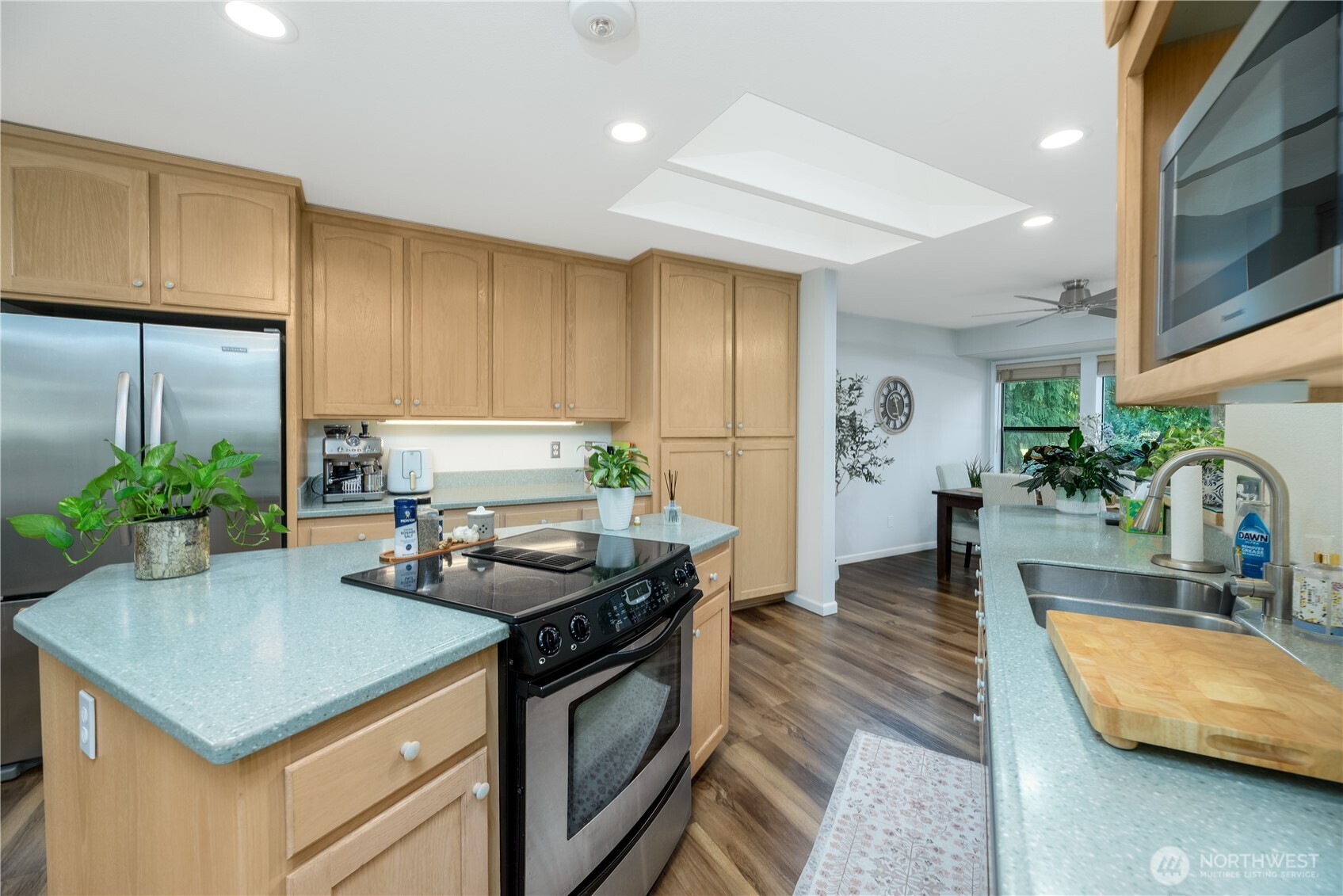 115 Fairway Drive Sequim, WA 98382 - Photo 15 of 39 a kitchen with stainless steel appliances granite countertop a stove a sink and a refrigerator