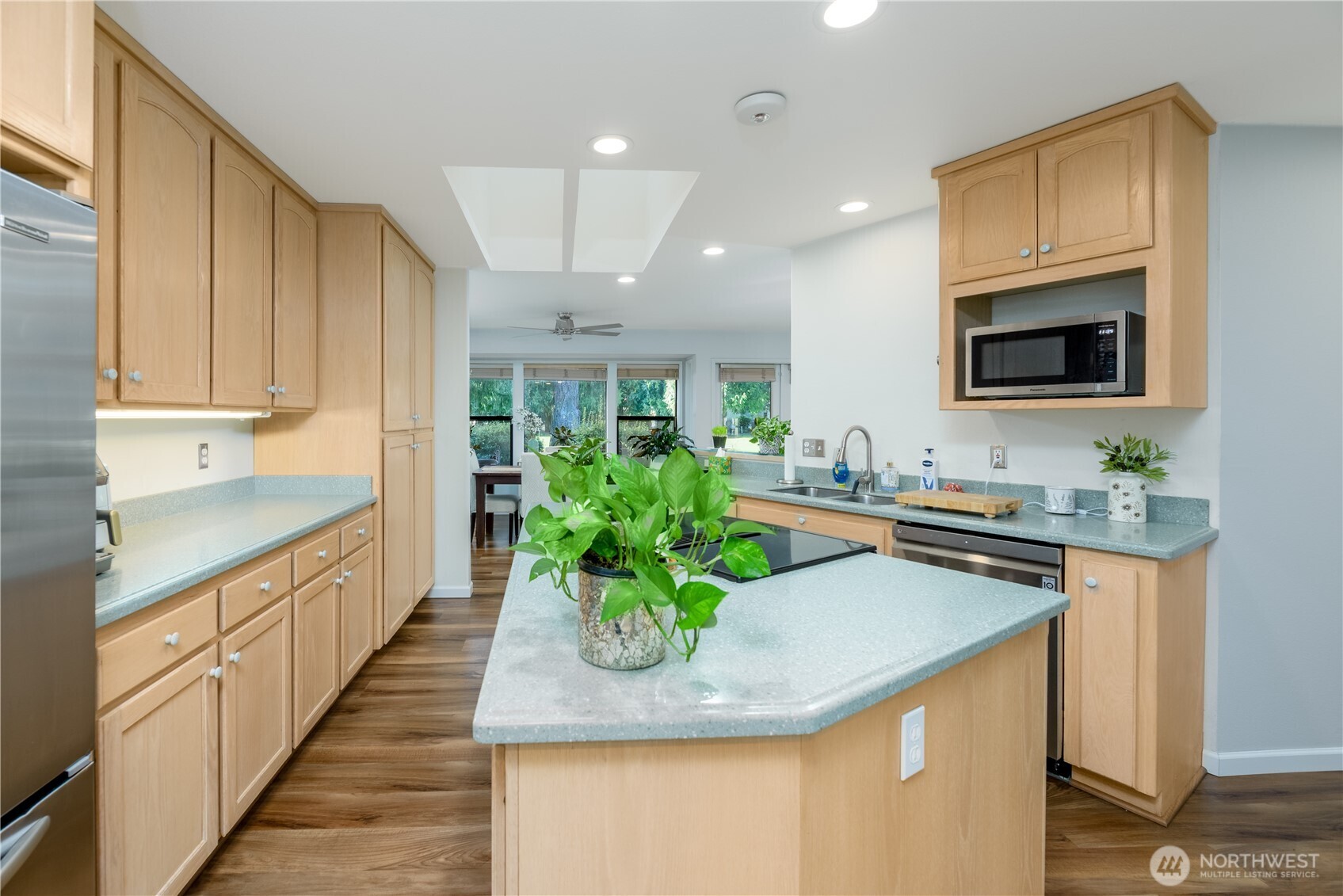 115 Fairway Drive Sequim, WA 98382 - Photo 16 of 39 a kitchen with sink a microwave and cabinets