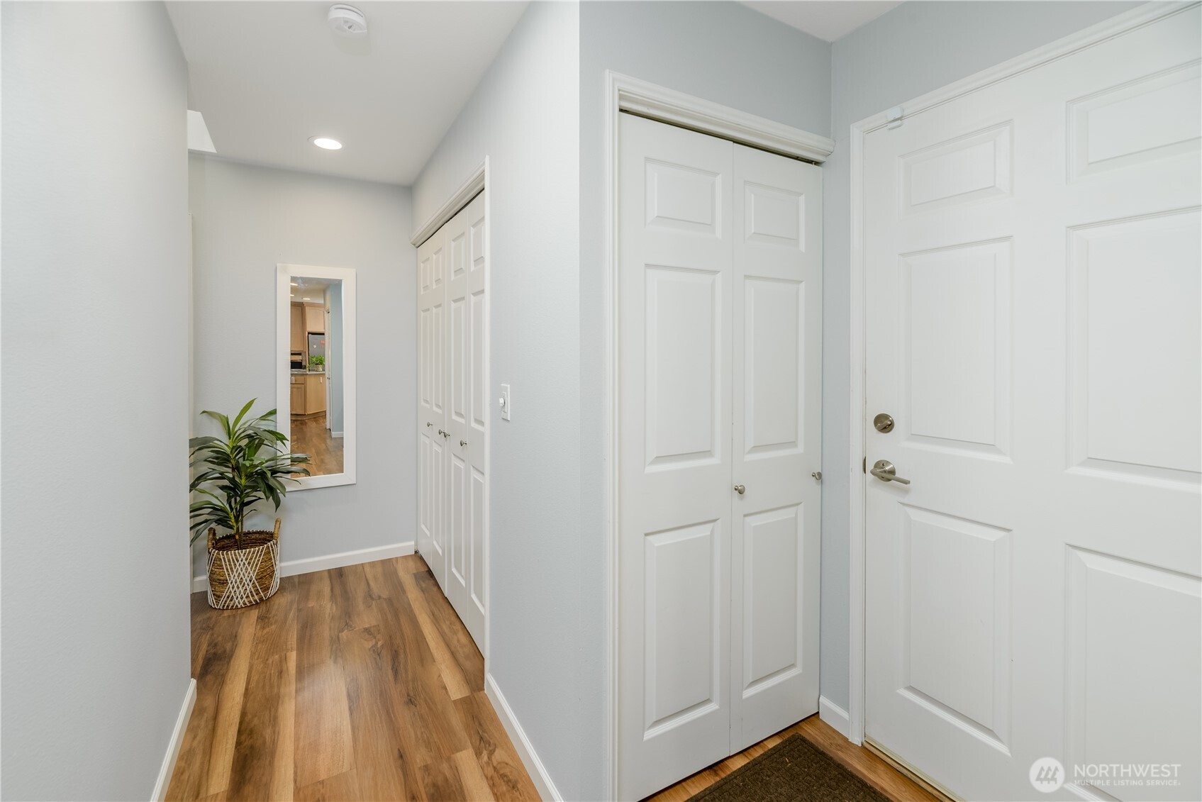 115 Fairway Drive Sequim, WA 98382 - Photo 22 of 39 a view of a hallway with wooden floor and a potted plant
