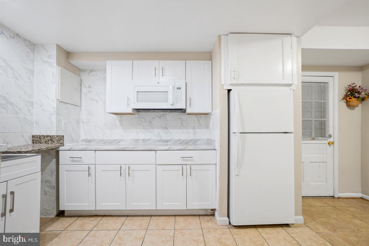 6871 Churchill Road McLean, VA 22101 - Photo 28 of 30 a kitchen with white cabinets and refrigerator