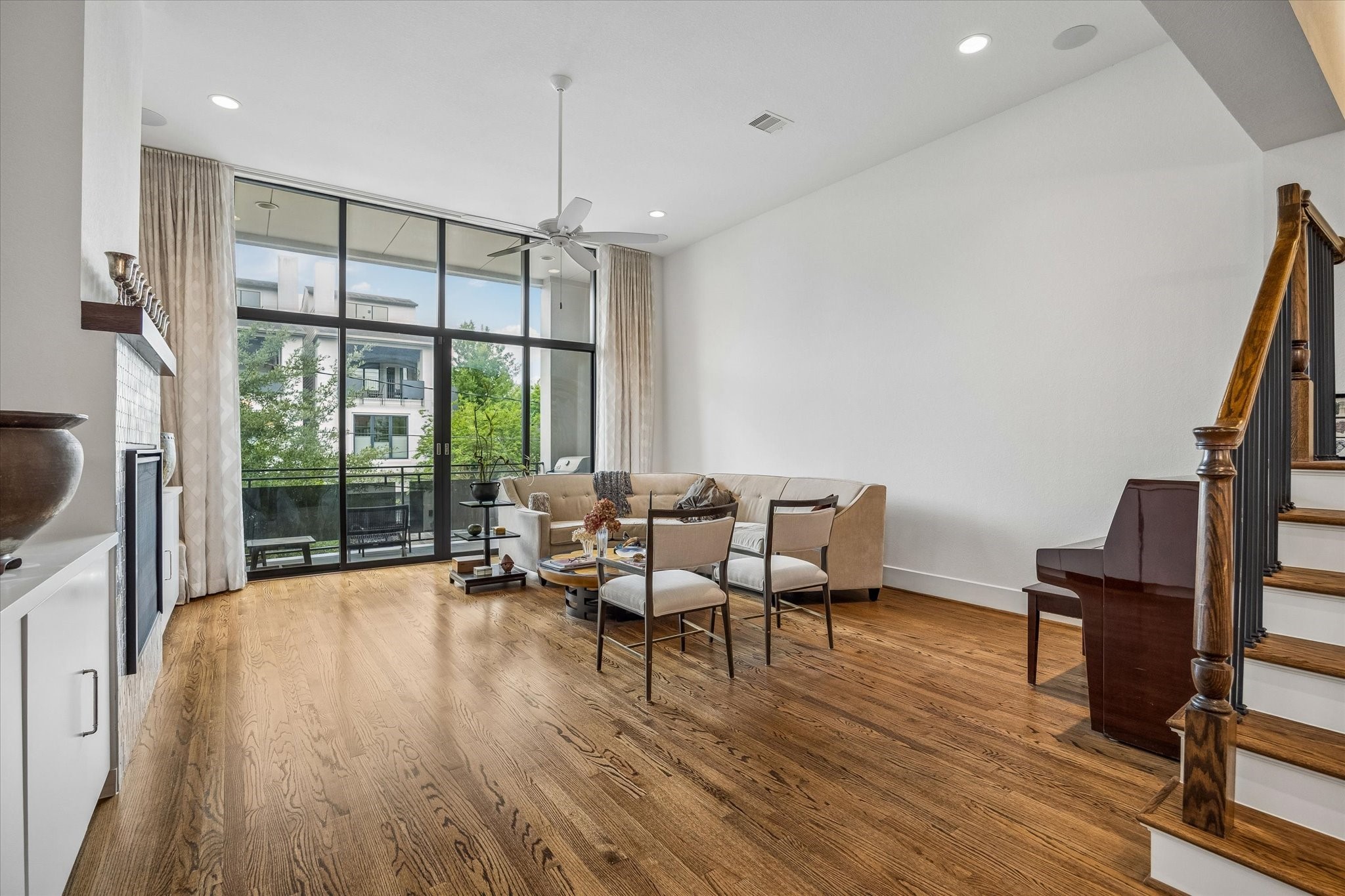 1526 Vermont Street Houston, TX 77006 - Photo 13 of 39 Spacious main living room with dramatic windows, hardwood floors, and direct access to the covered balcony.