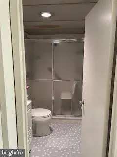 a bathroom with a toilet and a shower