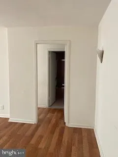 a view of a room with wooden floor