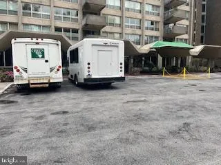 a view of building with cars parked in front of it