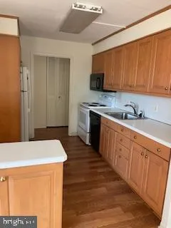 a kitchen with stainless steel appliances a stove a sink and a refrigerator