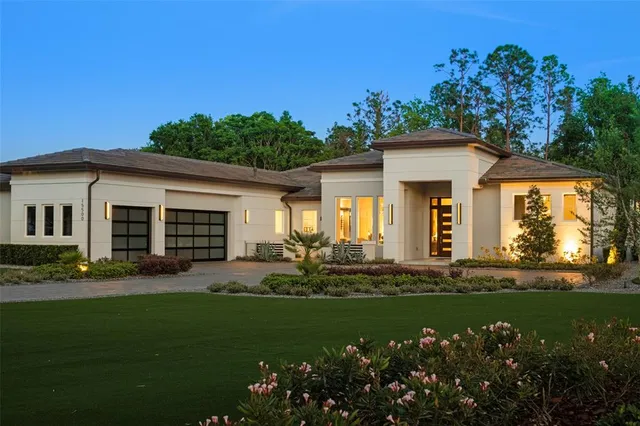 a front view of a house with a garden and yard