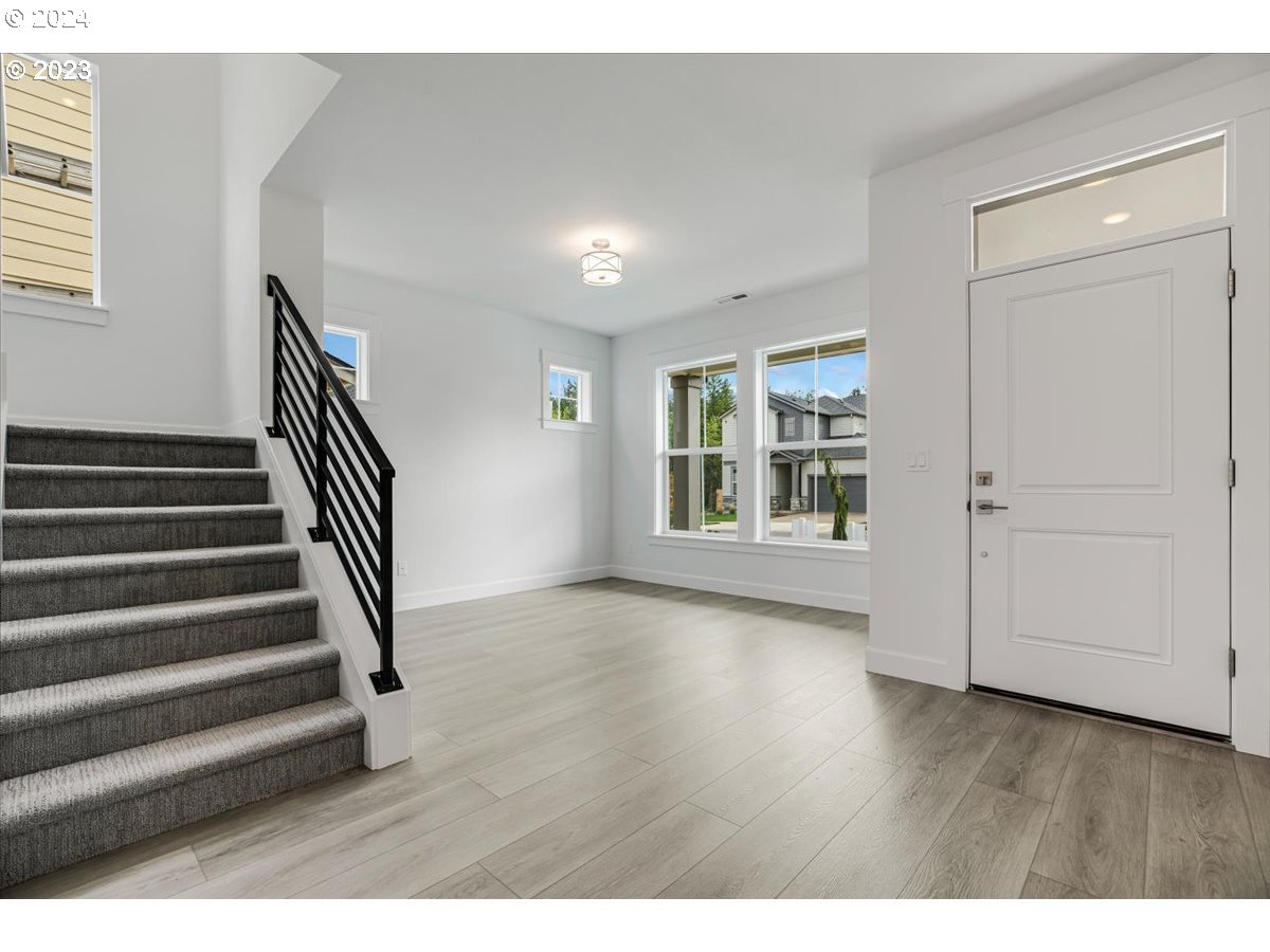 17127 Southwest Kalapuya Lane Sherwood, OR 97140 - Photo 2 of 18 a view of an room with wooden floor and windows