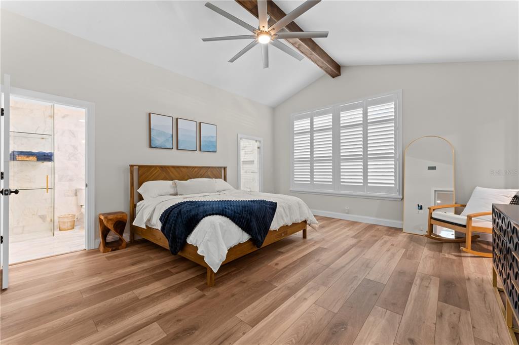 3300 Floramar Terrace New Port Richey, FL 34652 - Photo 14 of 75 a bedroom with a bed and wooden floor