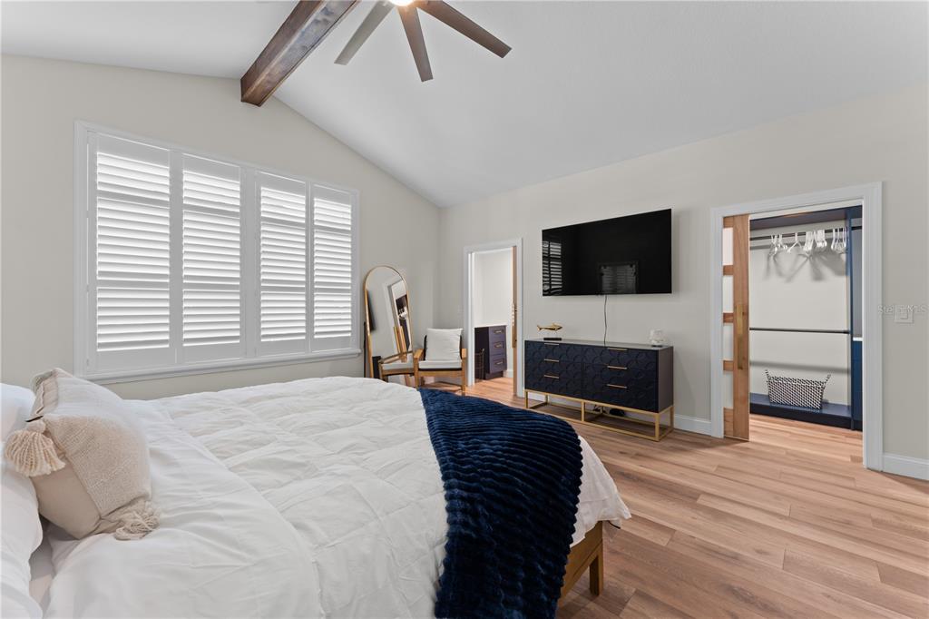 3300 Floramar Terrace New Port Richey, FL 34652 - Photo 15 of 75 a spacious bedroom with a bed and a flat screen tv