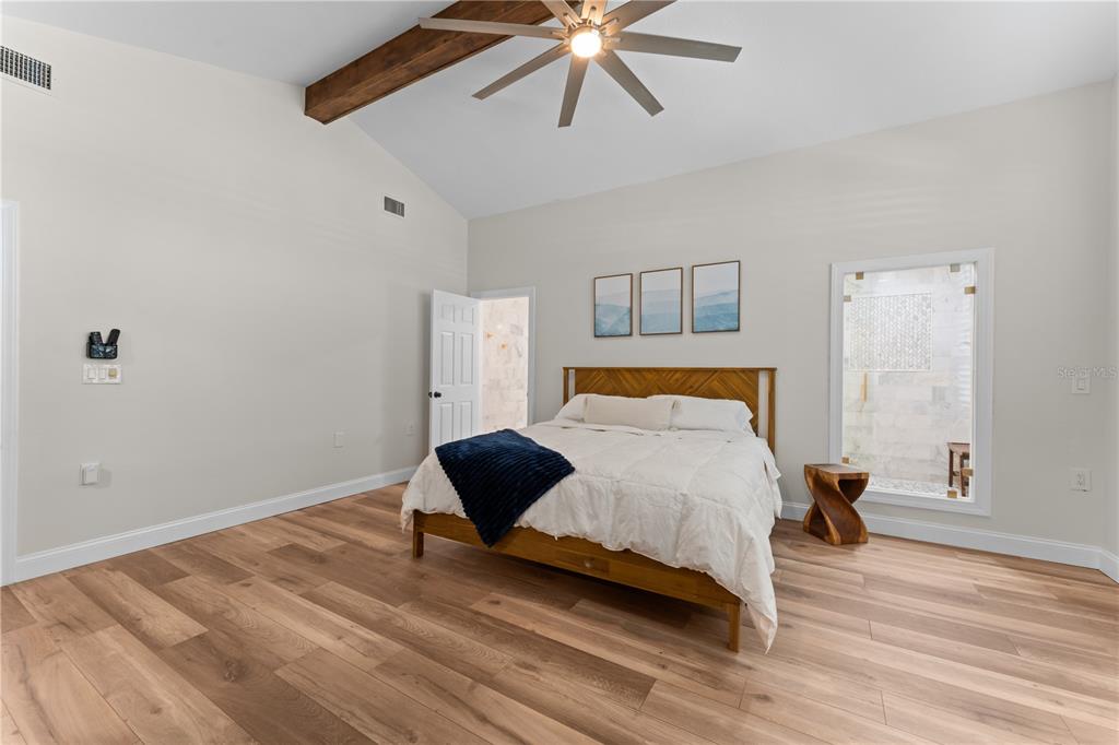 3300 Floramar Terrace New Port Richey, FL 34652 - Photo 16 of 75 a bedroom with a bed and a ceiling fan