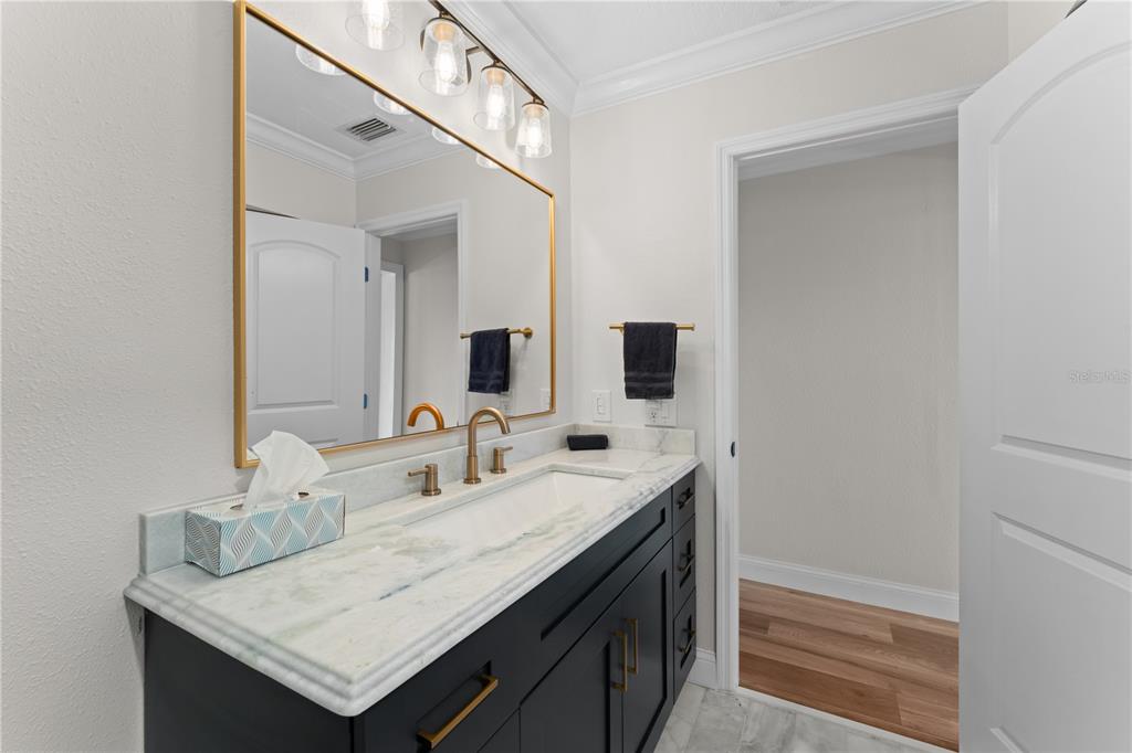 3300 Floramar Terrace New Port Richey, FL 34652 - Photo 37 of 75 a bathroom with a sink and a mirror