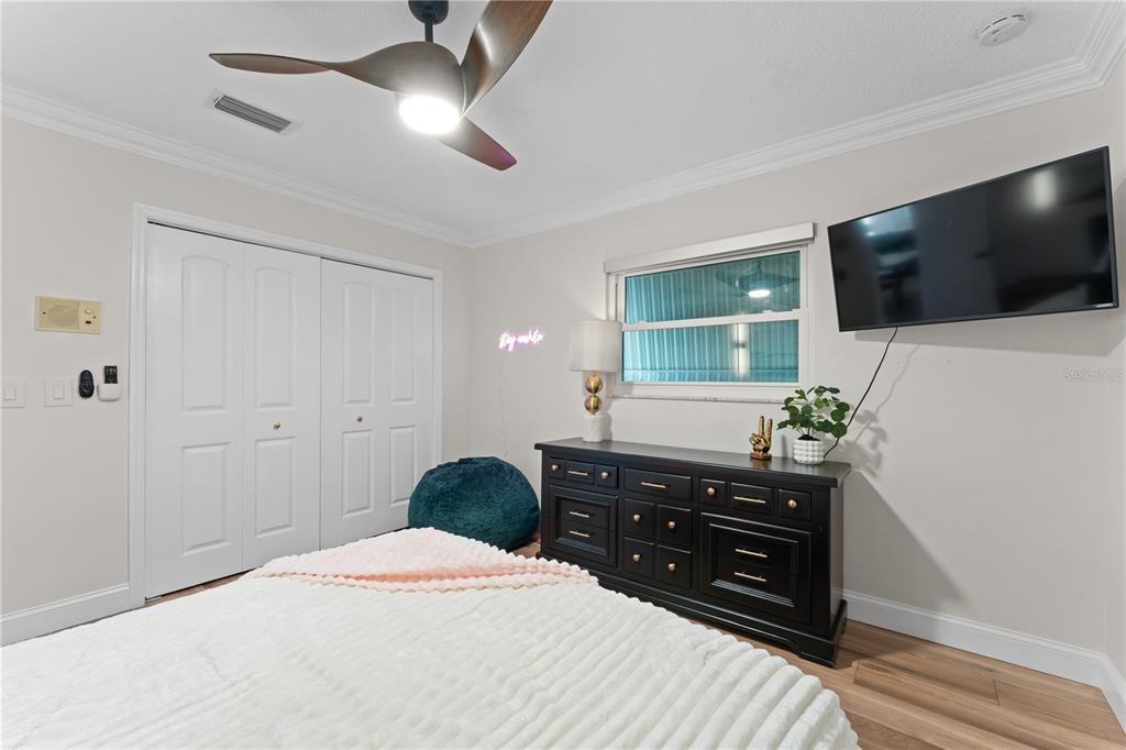 3300 Floramar Terrace New Port Richey, FL 34652 - Photo 42 of 75 a bedroom with a bed and a flat screen tv