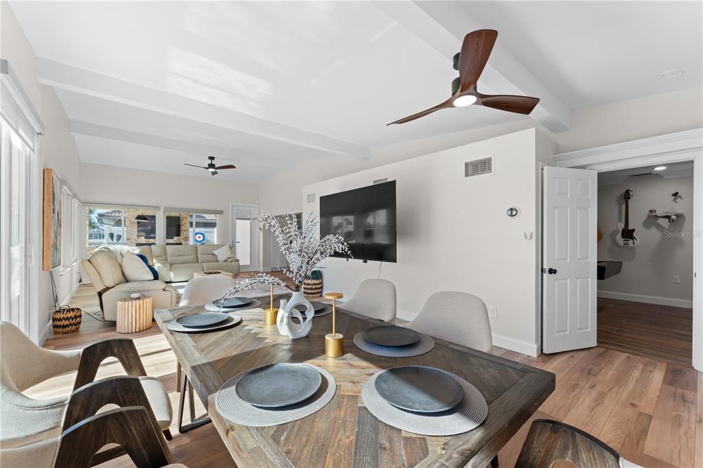 3300 Floramar Terrace New Port Richey, FL 34652 - Photo 49 of 75 a dinning room with furniture a rug and a flat screen tv