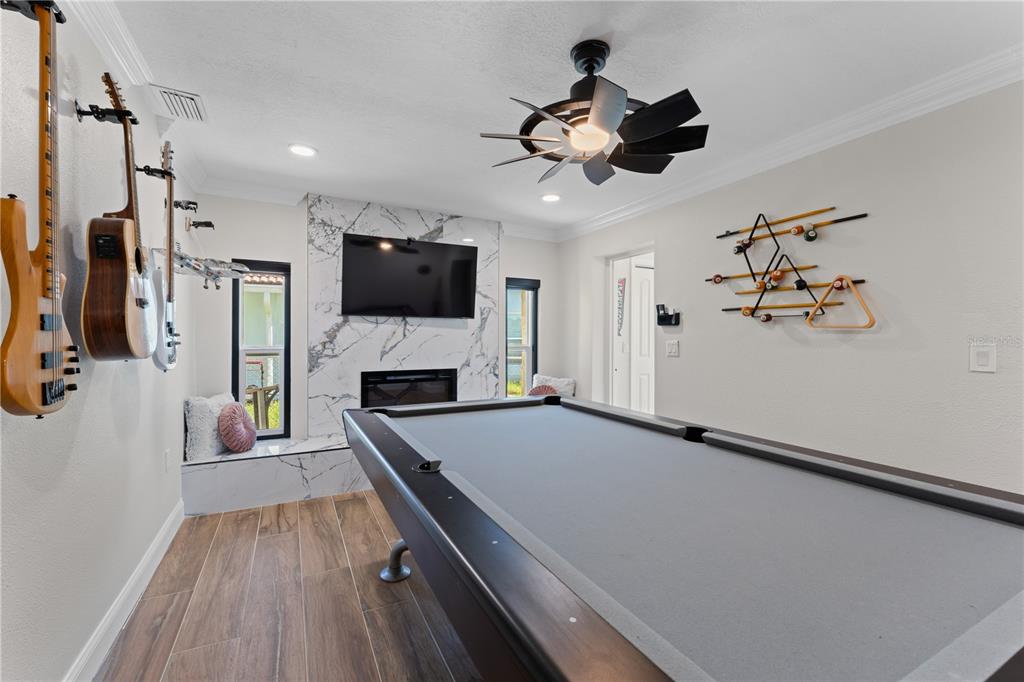 3300 Floramar Terrace New Port Richey, FL 34652 - Photo 53 of 75 a living room with furniture a flat screen tv and a ceiling fan