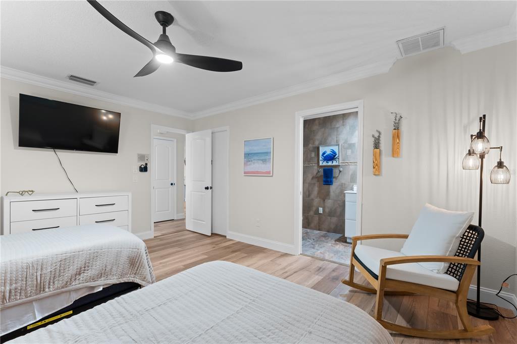 3300 Floramar Terrace New Port Richey, FL 34652 - Photo 57 of 75 a bedroom with a bed a flat screen tv and furniture