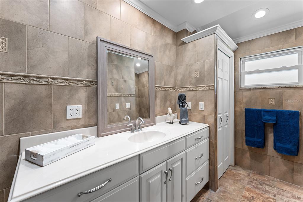 3300 Floramar Terrace New Port Richey, FL 34652 - Photo 58 of 75 a bathroom with a sink double vanity and a mirror