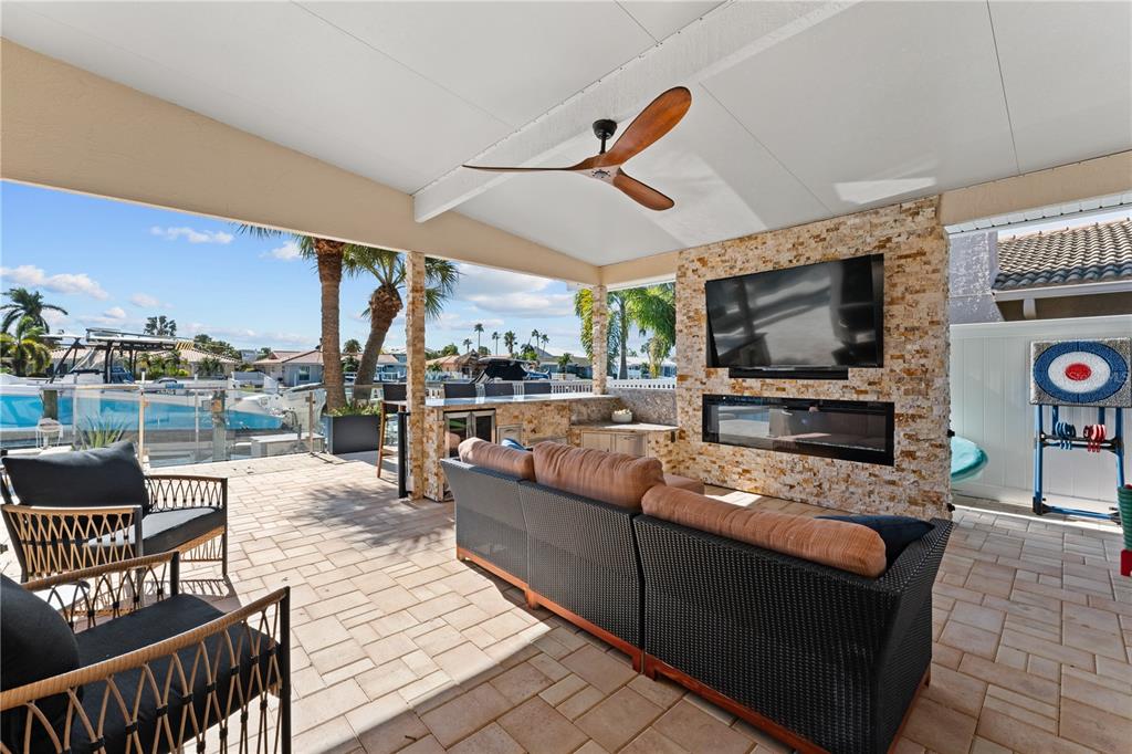 3300 Floramar Terrace New Port Richey, FL 34652 - Photo 62 of 75 a living room with furniture a flat screen tv and kitchen view