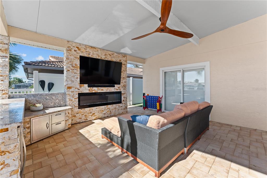 3300 Floramar Terrace New Port Richey, FL 34652 - Photo 64 of 75 a living room with fireplace furniture and a flat screen tv