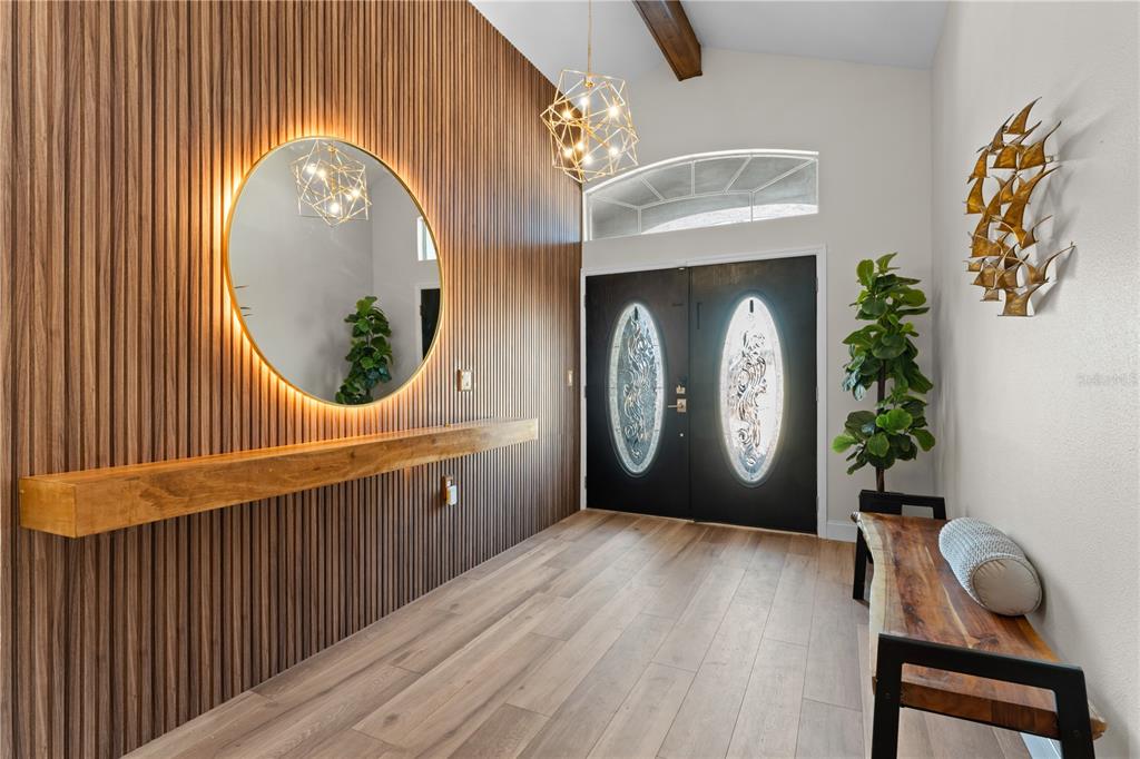 3300 Floramar Terrace New Port Richey, FL 34652 - Photo 7 of 75 a view of a hallway with entryway wooden floor and front door