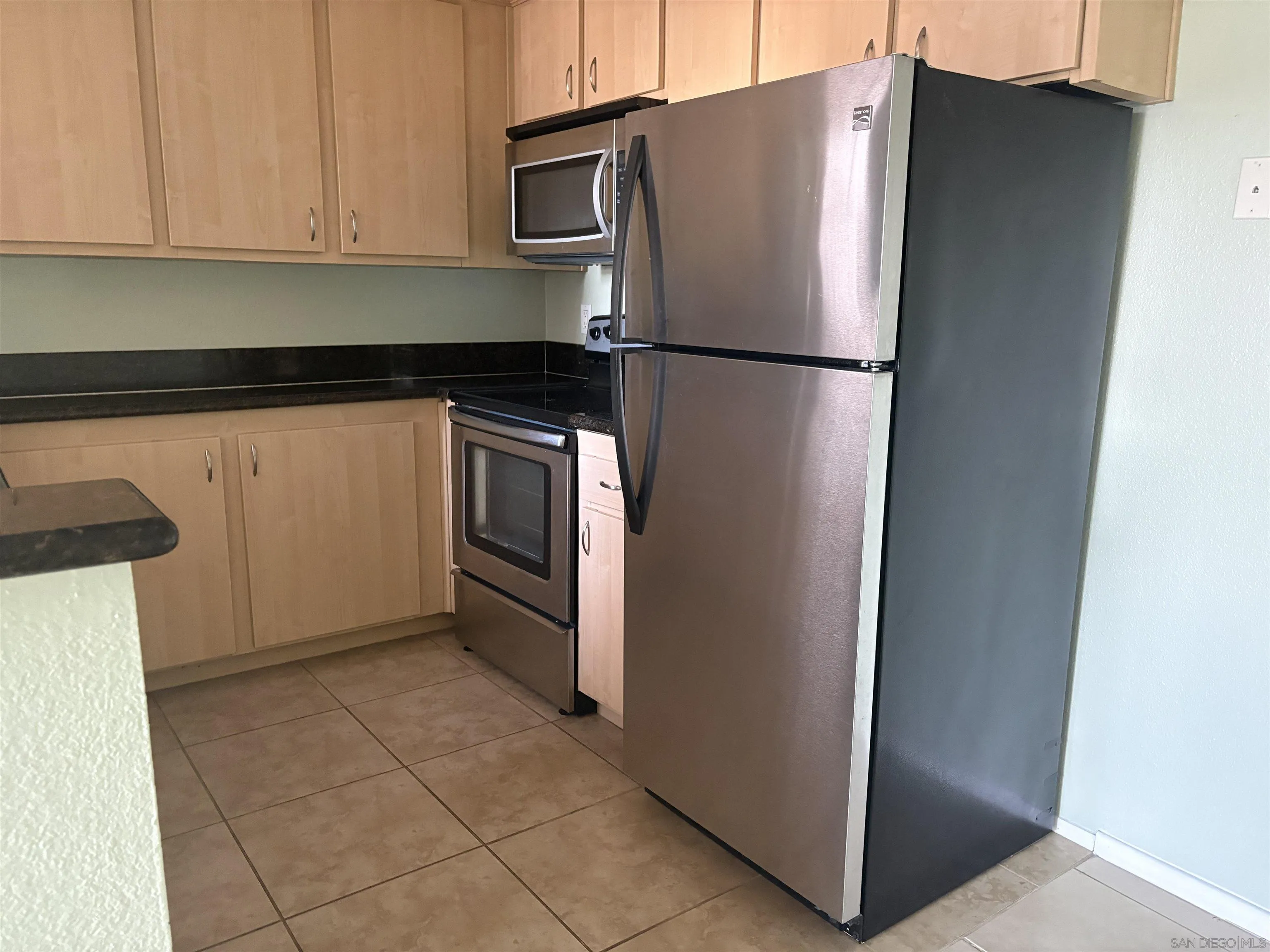 5962 Rancho Mission Road, Unit 222 San Diego, CA 92108 - Photo 21 of 42 a kitchen with metallic refrigerator freezer and a dishwasher