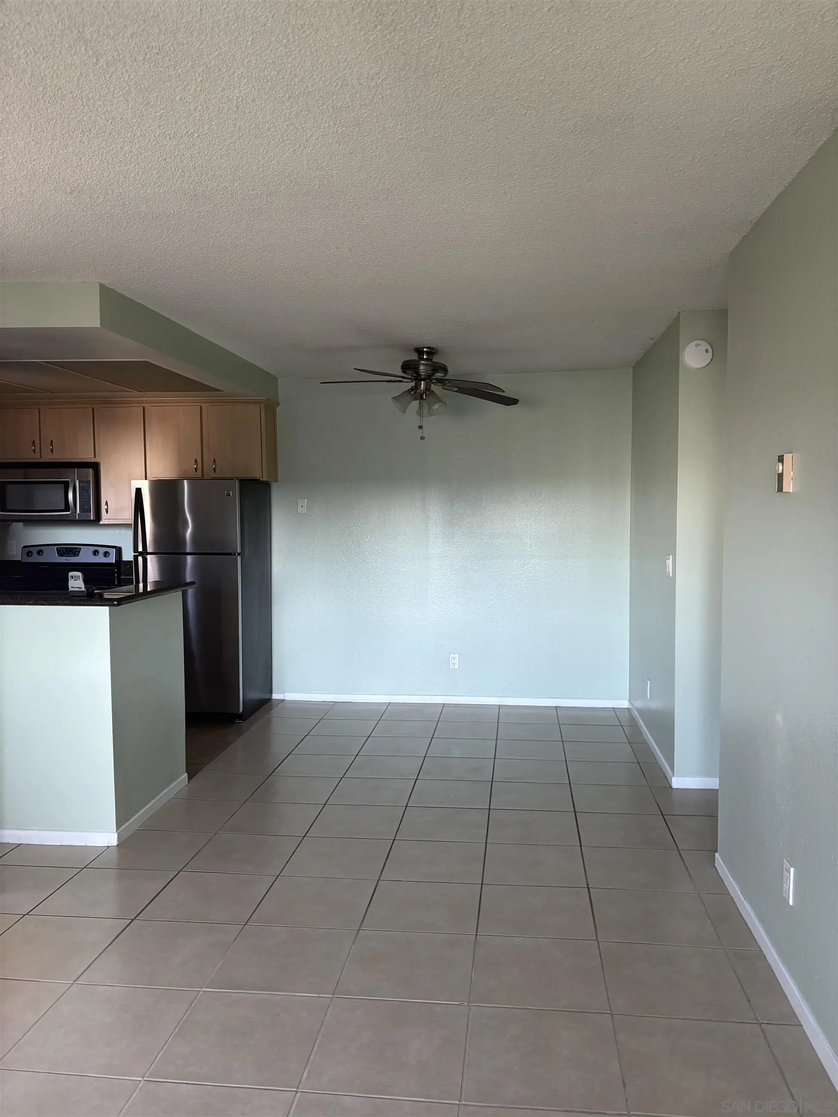 5962 Rancho Mission Road, Unit 222 San Diego, CA 92108 - Photo 23 of 42 a view of a kitchen with a sink and a refrigerator