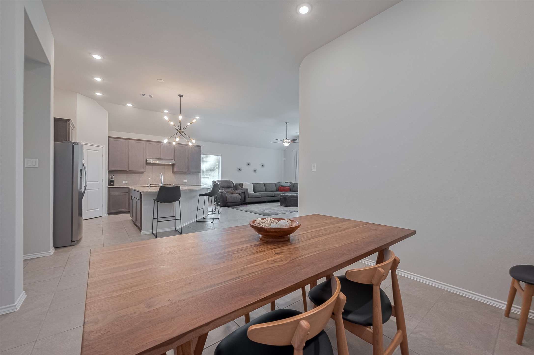 25446 Fossa Drive Tomball, TX 77375 - Photo 12 of 29 a dining room with kitchen island a table and chairs